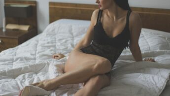 Woman in Black Nighties Lying on White Mattress