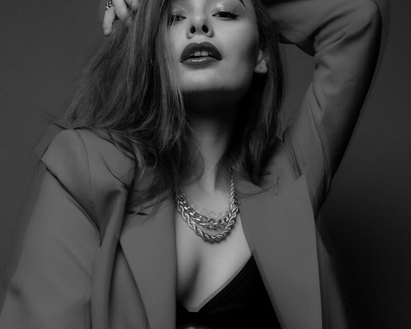 Stylish lady in bra and jacket in studio